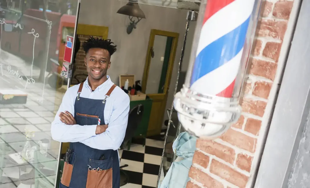 Man standing in door of barber shop